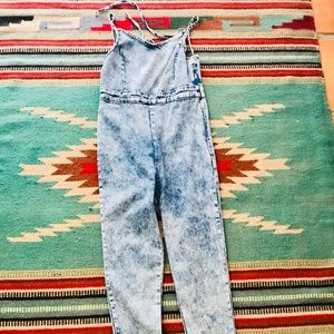 Acid washed stretchy denim halter jumpsuit.